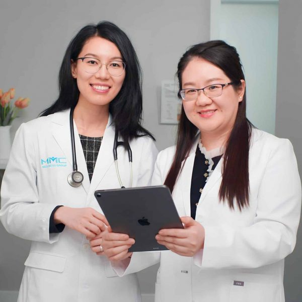 Two employees discussing HRT treatment options in a workplace setting.